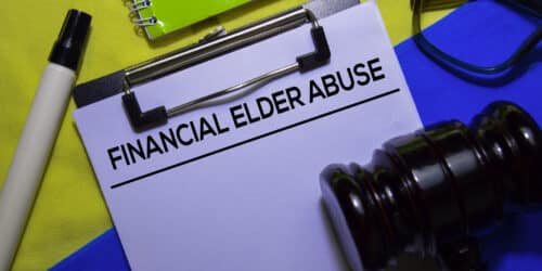 Financial Elder Abuse text on Document form and Gavel isolated on office desk.